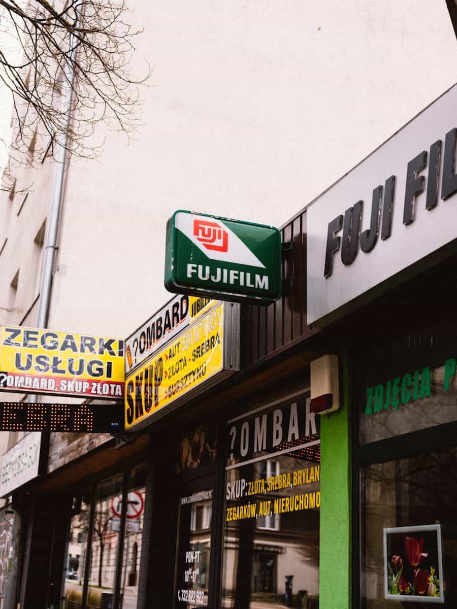 Photo of city street with vintage Fuji Film and pawn shop signs.
